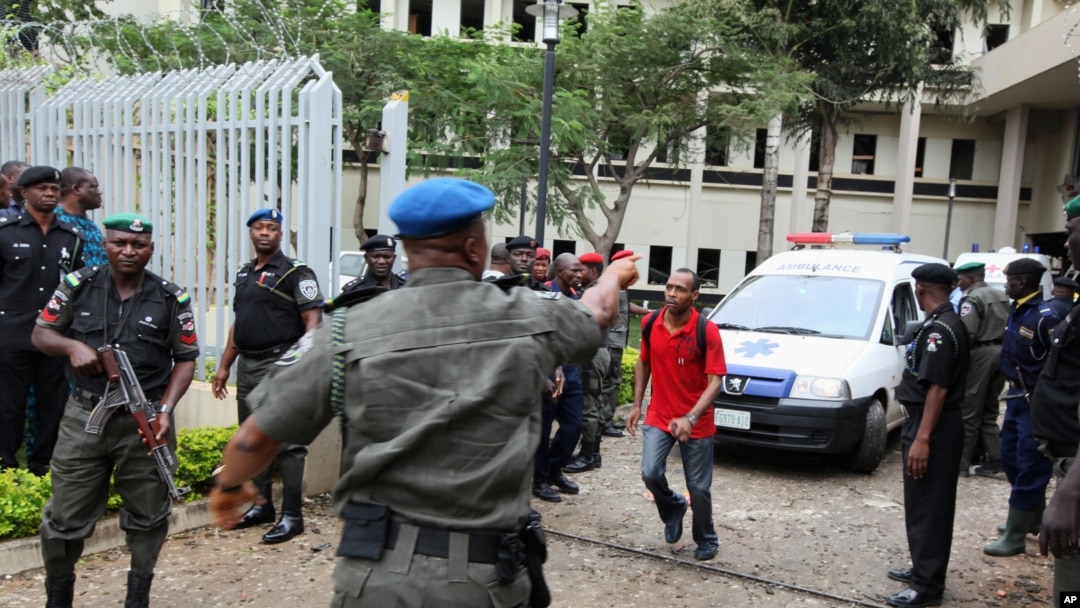 A U.N. staff member directs an ambulance after a bomb blast that ripped through the United Nations offices in the Nigerian capital of Abuja.