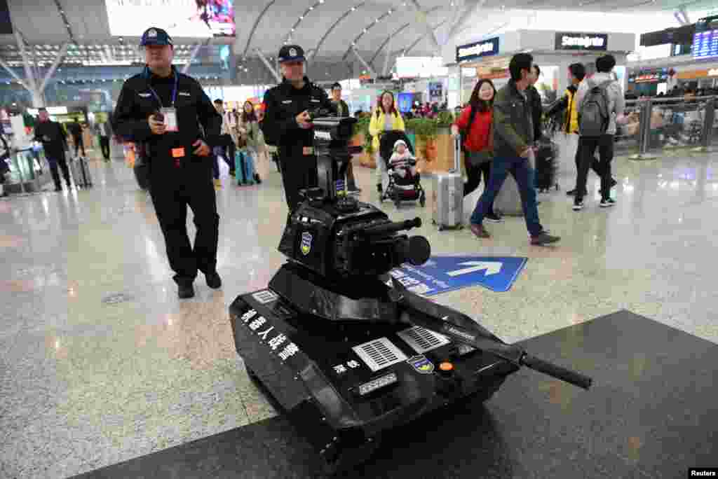 Police officers operate a security robot to patrol inside a railway station as the annual Spring Festival travel rush starts ahead of the Chinese Lunar New Year, in Shenzhen, Guangdong province, China, Jan. 21, 2019.