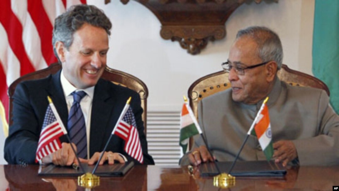 Treasury Secretary Timothy Geithner, left, and Indian Finance Minister Pranab Mukherjee smile after signing a joint statement on the U.S.-India Economic and Financial Partnership, Tuesday, June 28, 2011