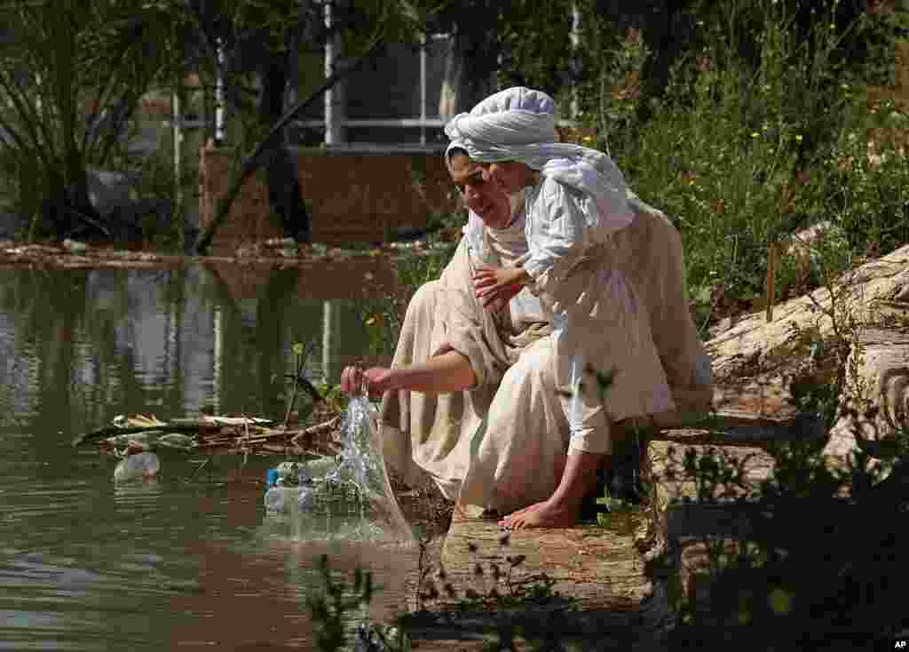 Followers of the Sabean Mandaeans, a pre-Christian sect that follows the teachings of John the Baptist, perform their rituals alongside the Tigris river during a celebration marking 'Banja' or Creation Feast in central Baghdad, Iraq.