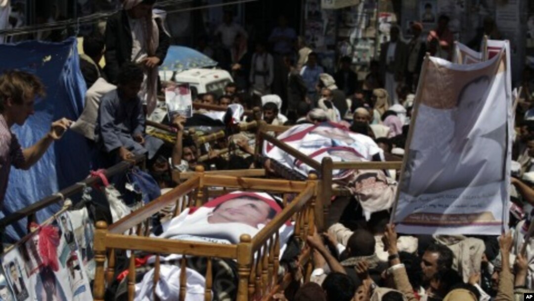 Anti-government protestors carry the bodies of those who were killed during recent clashes with security forces during their funeral procession in Sanaa, Yemen, September 25, 2011.