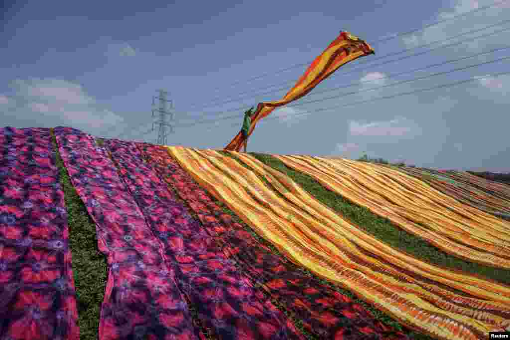 A worker throws a cloth during a drying process at Sukoharjo near Solo, Central Java province, Indonesia, in this photo taken by Antara Foto.