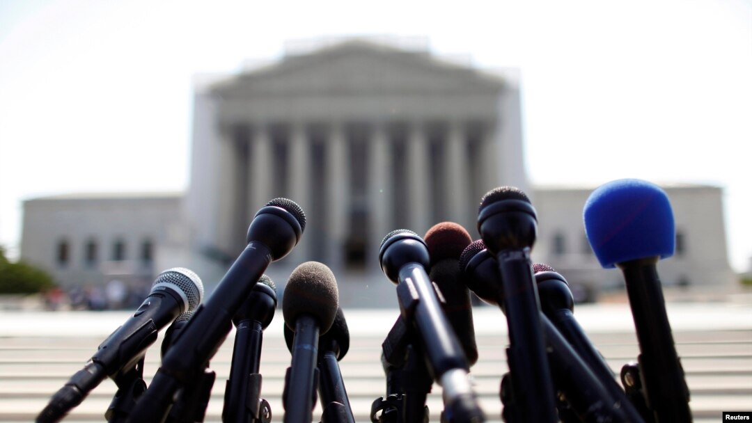 FILE - News microphones wait to capture reactions from US Supreme Court rulings outside the court building in Washington.