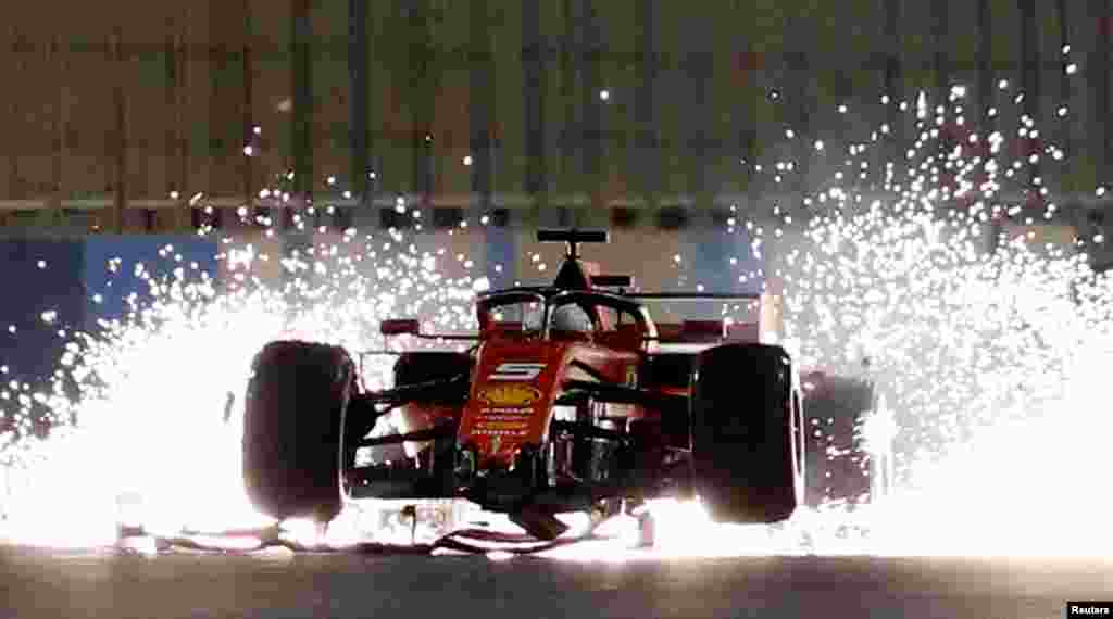 Ferrari's Sebastian Vettel steers his damaged car during the Formula One Bahrain Grand Prix at the Sakhir circuit in the desert south of the Bahraini capital Manama, March 31, 2019.