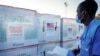 FILE - A worker checks boxes of a coronavirus vaccine following their delivery at the airport in Nairobi, Kenya, Aug. 23, 2021. 