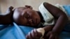 FILE - A young girl with malaria rests in the inpatient ward of the Malualkon Primary Health Care Center in Malualkon, in the South Sudanese state of Northern Bahr el Ghazal.