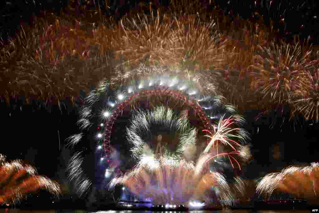 Fireworks explode around the London Eye during New Year's celebrations in central London just after midnight.