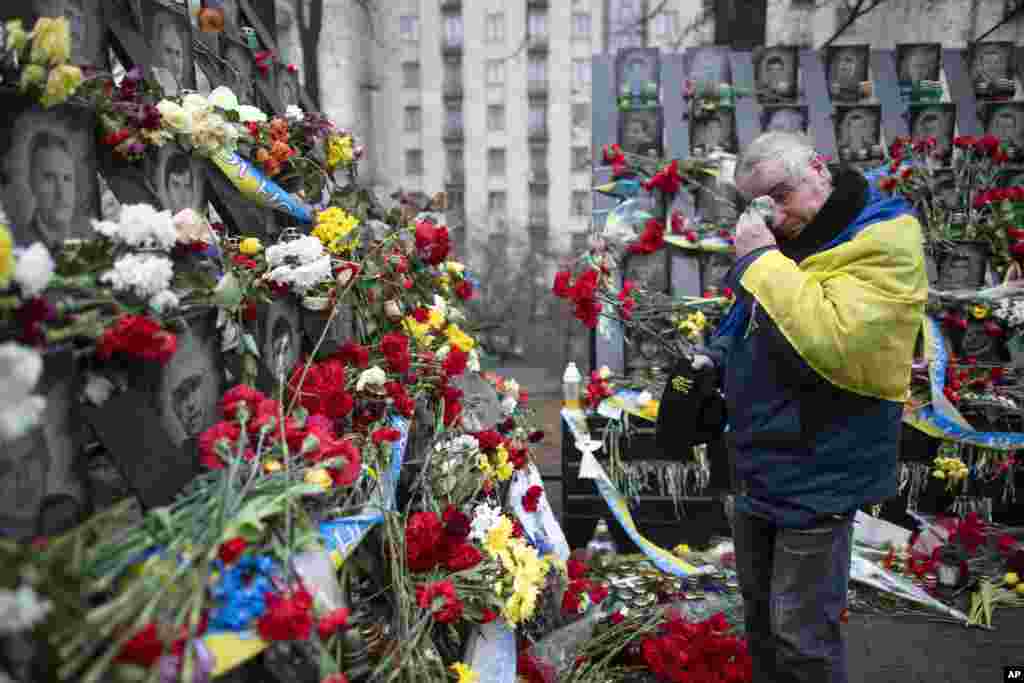 A man cries as he pays his respects at a memorial at the Independent Square (Maidan) in Kyiv, Ukraine, dedicated to people who died in clashes with security forces five years ago.