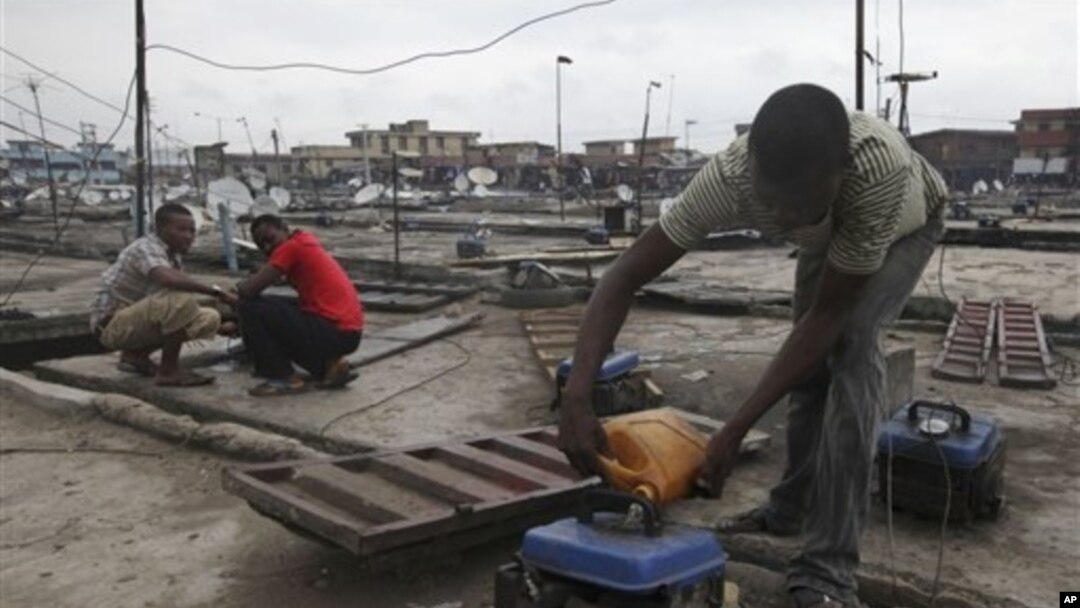 Due to Nigeria's decrepit national power grid, a man refuels a small generator in central Lagos, August 2010.