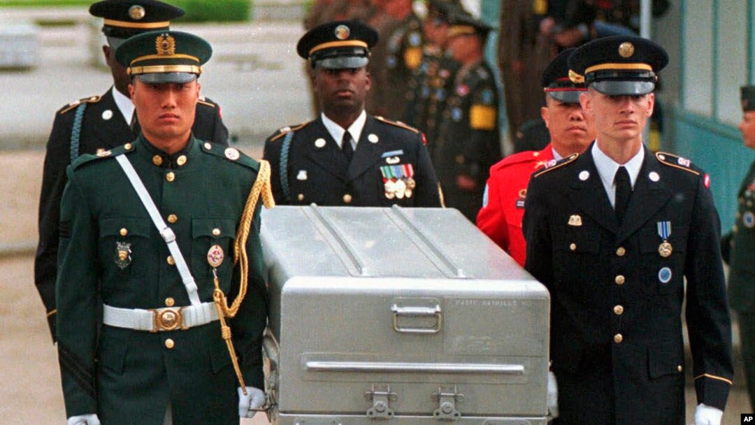 FILE - U.N. honor guards carry a coffin containing the remains of an American soldier after they were returned by North Korea, at the border village of Panmunjom, South Korea, May 14, 1999.