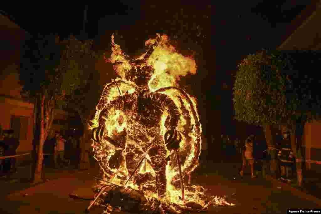 A figure representing the devil burns during the celebration of the Virgin of the Immaculate Conception, in Guatemala City, Dec. 7, 2021. The event marks the beginning of the Christmas season in the country.