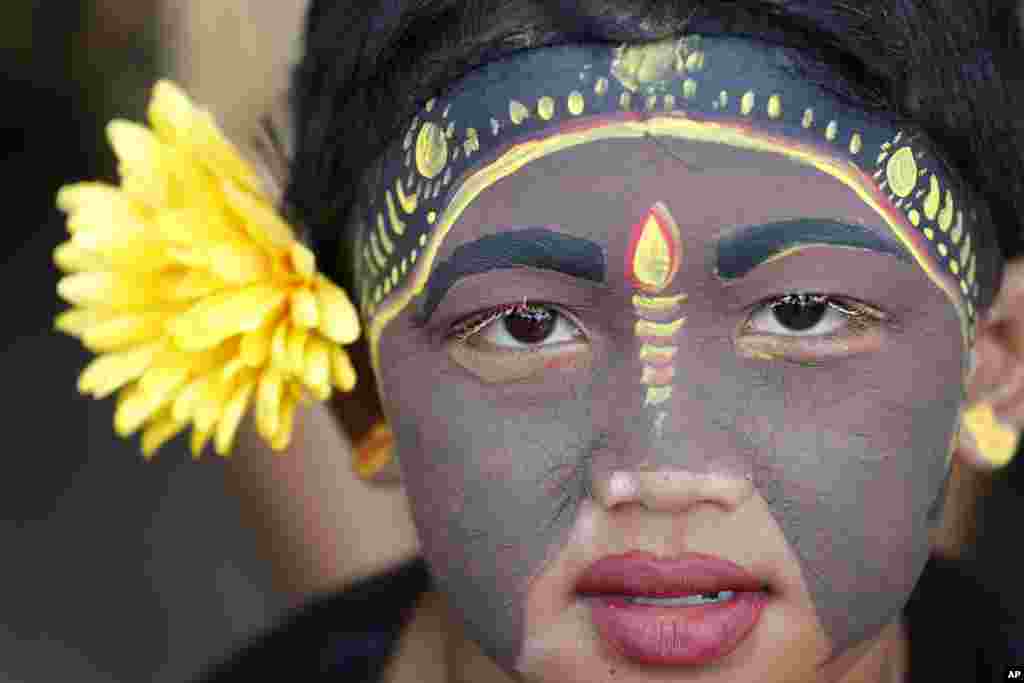 A Balinese youth participates in the Hindu ritual of "Grebeg" at the Tegalalang village in Bali, Indonesia.