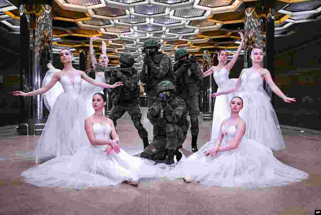 An undated photo provided by Russian Defense Ministry Press Service, shows soldiers and ballerinas posing for a photoshoot in Yekaterinburg to mark International Women's Day.