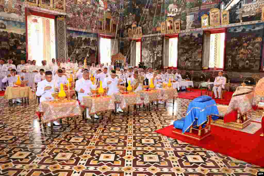 Royal astrologers and members of the Royal Thai court participate in a ritual ahead of the coronation to inscribe Thai King Maha Vajiralongkorn's name and title, cast the king's horoscope, and engrave the king's official seal at the Wat Phra Kaew or the Temple of the Emerald Buddha in Bangkok, Thailand.