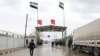 FILE - People cross from Turkey into northern Syria at the Bab al-Salam border crossing, March 13, 2020. 