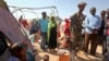 A Somali soldier provides security as newly displaced Somalis gather at a camp on the outskirts of Mogadishu, Somalia, March 28, 2017. A new report says cross-border airstrikes by Kenya have been targeting civilians in pastoral communities in Somalia's Gedo region.