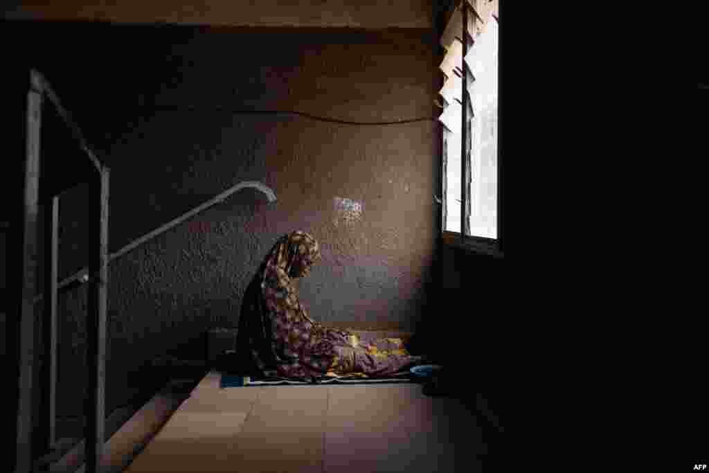 A worshipper prays at the Great Mosque in Ouagadougou. Burkina Faso, the scene of a military coup this week, was suspended from the Community of West African States (ECOWAS), following a virtual summit of the organization.