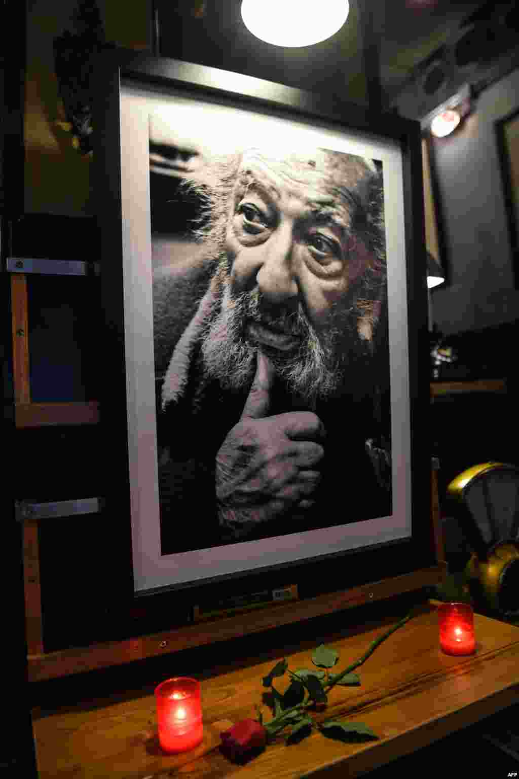 Candles and a rose have been put next to a portrait of late Turkish photographer Ara Guler at Ara Cafe in Istanbul. The legendary photographer, famed for iconic images of Istanbul which captured almost three quarters of a century of the city's history, died aged 90 on Oct. 17, 2018.