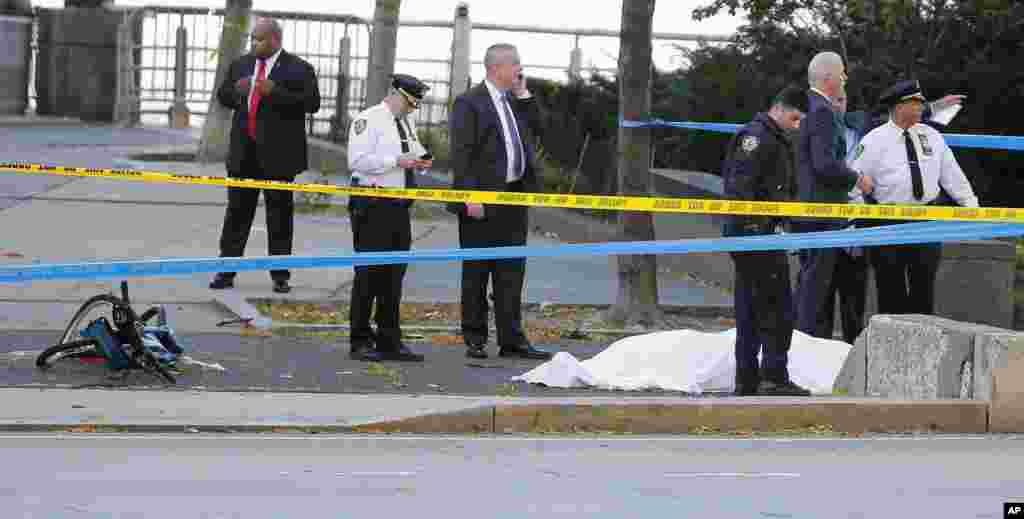 Manhattan ShootingLas autoridades investigan la escena alrededor de un cuerpo cubierto debajo de una sábana blanca junto a una bicicleta destrozada a lo largo de un carril de bicis. Martes 31 de octubre de 2017, Nueva York. 