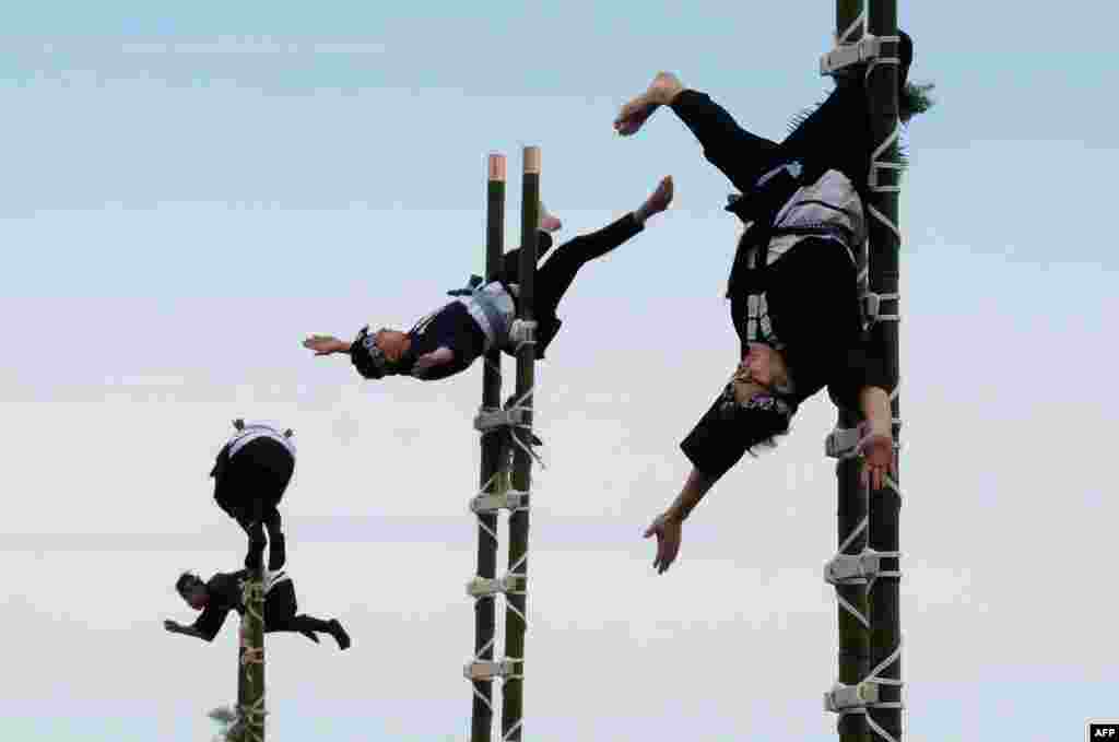 Members of the Edo Firemen Preservation Association perform Japanese traditional firefighting techniques during the New Year's fire brigades exercise in Tokyo.
