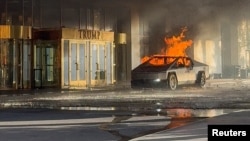 Flames rise from a Tesla Cybertruck after it exploded outside the Trump International Hotel Las Vegas, in Las Vegas, Nevada, Jan. 1, 2025 in this screengrab taken from a social media video. (Antunes via Reuters)