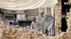 Earthquake victims are seen digging through rubble in an image posted on the campaign homepage of GlobalGiving.org. (Courtesy - GlobalGiving)