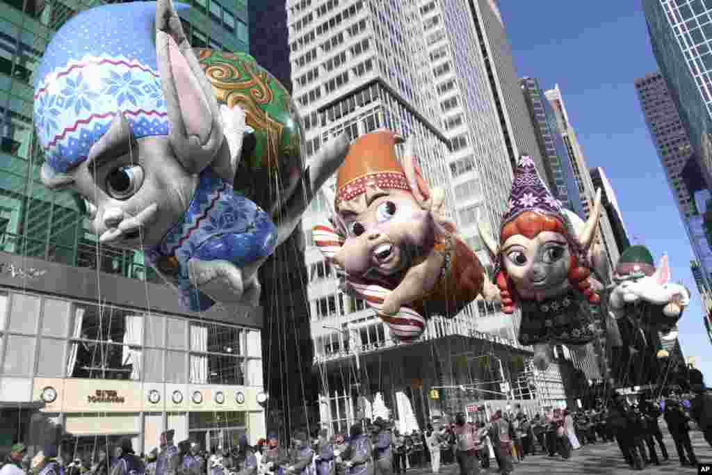 The Fleck, Bjorn, Jojo, and Hugg balloons make their way down New York's Sixth Avenue during the 92nd annual Macy's Thanksgiving Day Parade, in New York.
