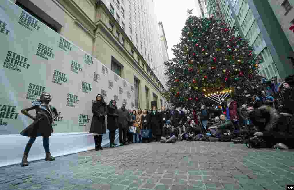 The Fearless Girl statue is unveiled at her new home facing the New York Stock Exchange (NYSE) during an event held by the city of New York and State Street Global Advisors.