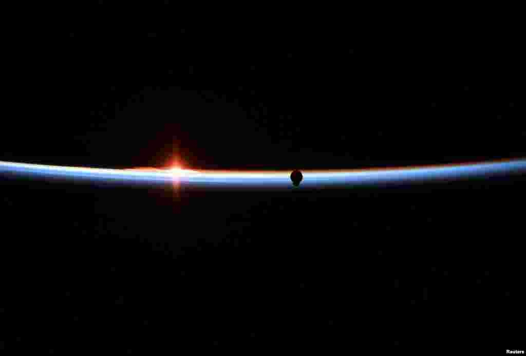 The SpaceX Crew Dragon capsule approaches in a photograph taken by NASA astronaut Anne McClain aboard the International Space Station, March 3, 2019.