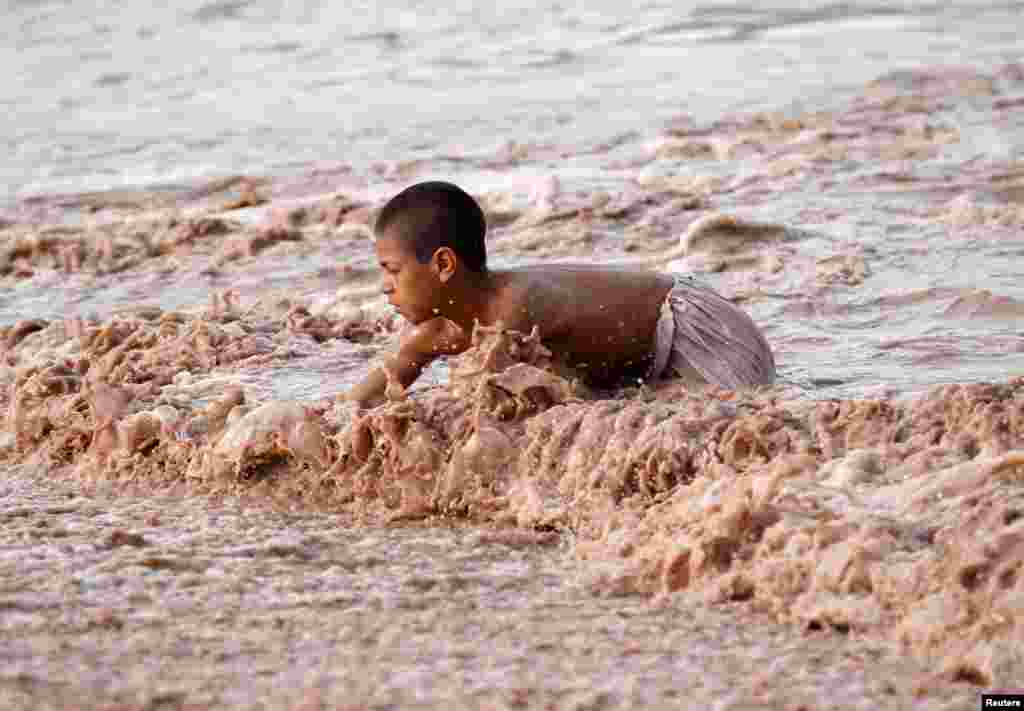 A boy swims in muddy water in Jalalabad province, Afghanistan.