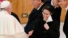 FILE - In this Dec. 23, 2021, file photo, Pope Francis, left, shakes hands with Sister Raffaella Petrini at the Vatican. On Saturday, she was named president of the Vatican City State.