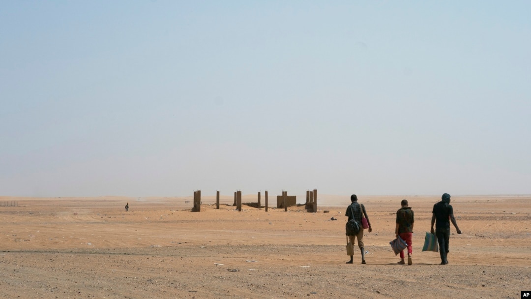 Three men head north towards Algeria after crossing the Assamaka border post in northern Niger, June 3, 2018.