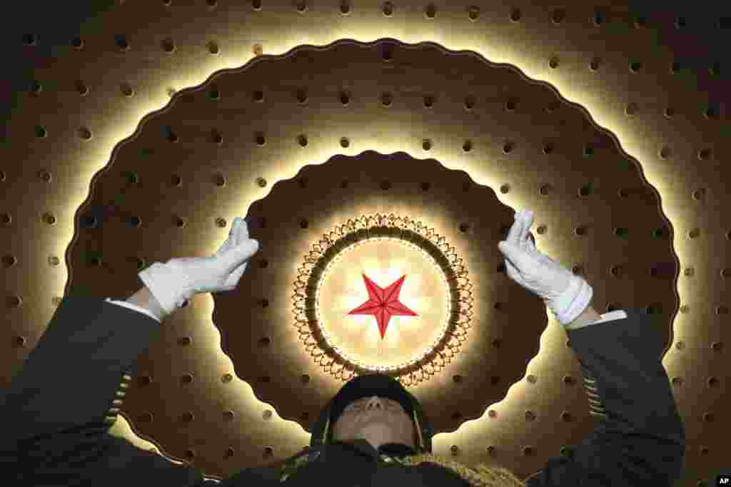 A Chinese military band conductor leads the band to rehearse before the opening session of the Chinese People's Political Consultative Conference (CPPCC), in Beijing's Great Hall of the People.