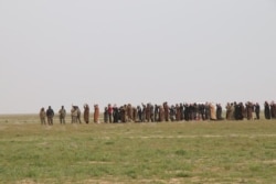 As IS lost holdings across Iraq and Syria between 2016 and 2018, women and men would be separated as authorities searched for militants, pictured near Baghouz, Syria, Feb. 27, 2019. (H.Murdock/VOA)