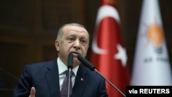 FILE - Turkish President Recep Tayyip Erdogan addresses lawmakers from his ruling AK Party during a meeting at the parliament in Ankara, Turkey, Nov. 26, 2019. (Presidential Press Office/Handout)