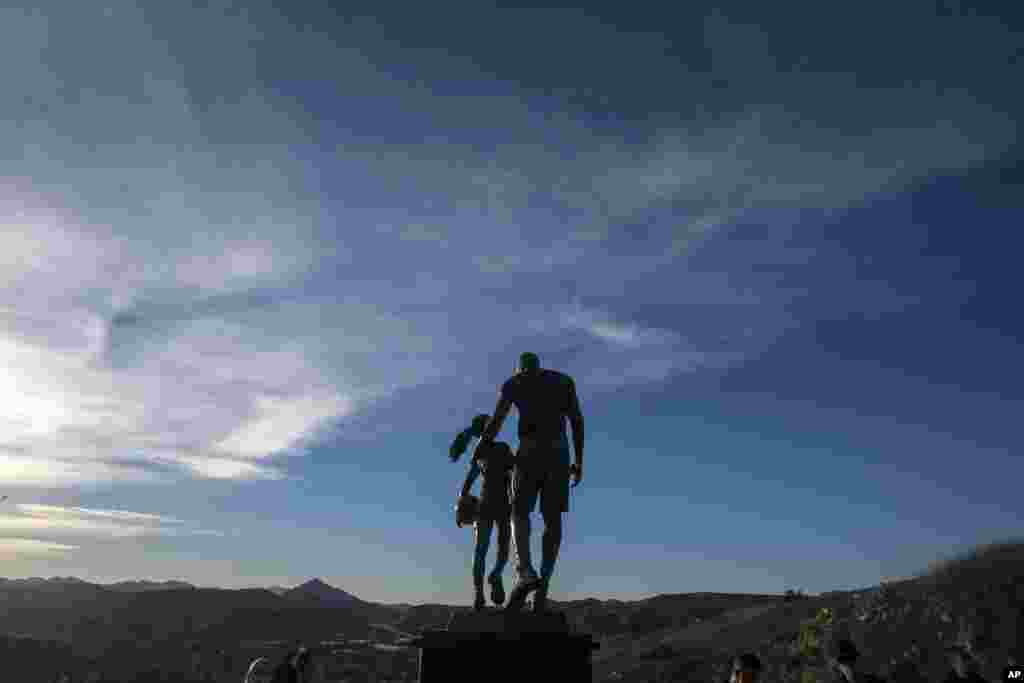 A bronze sculpture honoring former NBA player Kobe Bryant of the Los Angeles Lakers, his daughter Gianna Bryant, and the names of the others who died, is displayed at the site of a 2020 helicopter crash, on a hillside in Calabasas, California, Jan. 26, 2022.