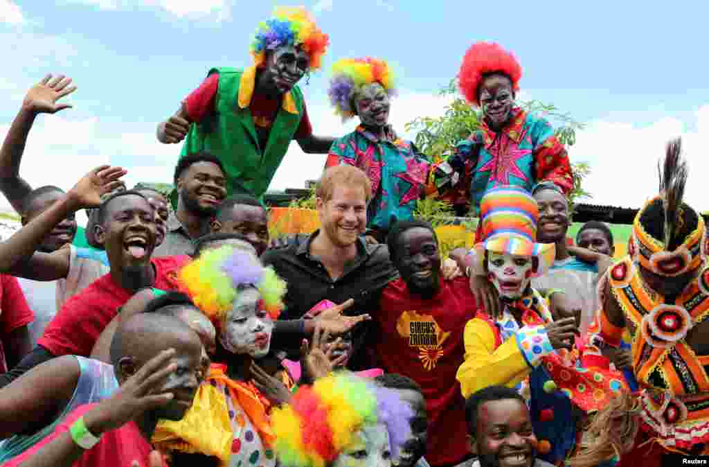 Youths pose for a photograph with Britain's Prince Harry during his visit to Circus Zambia in Lusaka.