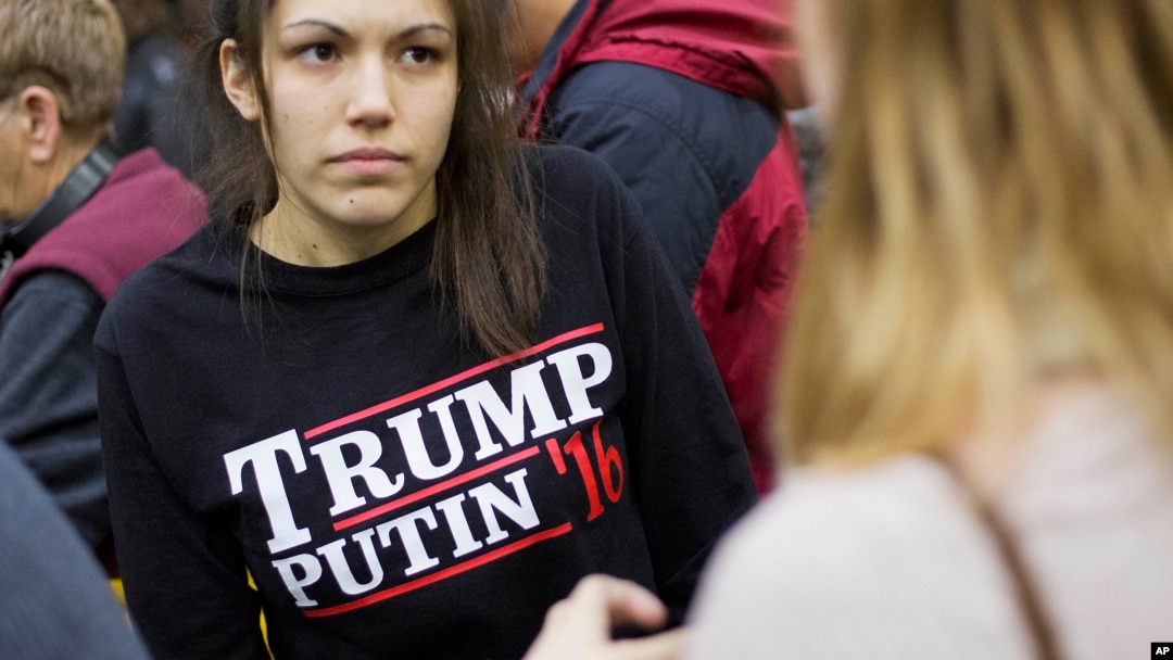 FILE - A woman wears a shirt reading "Trump Putin '16" while waiting for Republican presidential candidate Donald Trump to speak at a campaign event at Plymouth State University in Plymouth, N.H., Feb. 7, 2016.