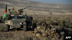FILE - In this photograph taken on December 3, 2016, Afghan security forces take positions following an operation against Islamic State (IS) militants in Pachir Wa Agam district of Nangarhar province.