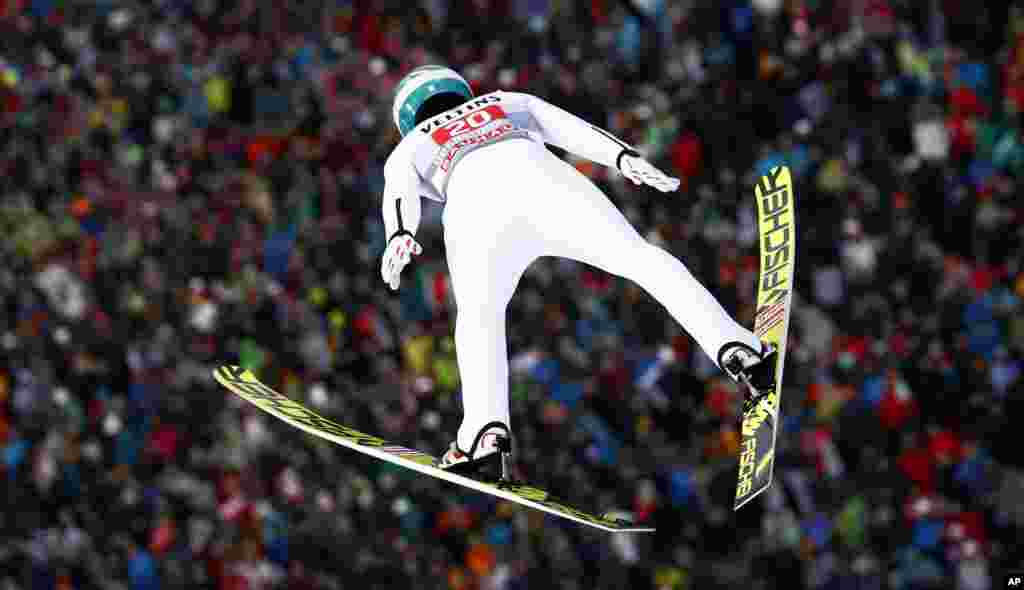 Austria's Michael Hayboeck soars through the air during a trial jump at the first stage of the 67th four hills ski jumping tournament in Oberstdorf, Germany.