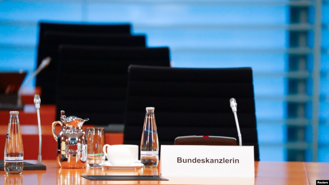 FILE - The empty chair of German Chancellor Angela Merkel is seen as she participates in the weekly cabinet meeting by video, since she has gone into home quarantine because of the coronavirus disease, in Berlin, Germany, March 23, 2020.