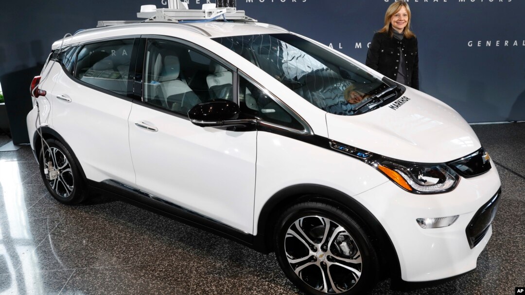 FILE - General Motors Chairman and Chief Executive Officer Mary Barra stands next to an autonomous Chevrolet Bolt electric car, Dec. 15, 2016, in Detroit.
