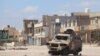 A burnt-out vehicle is left behind after a recent battle in a once-crowded suburb of Tripoli, Libya, April 28, 2019.