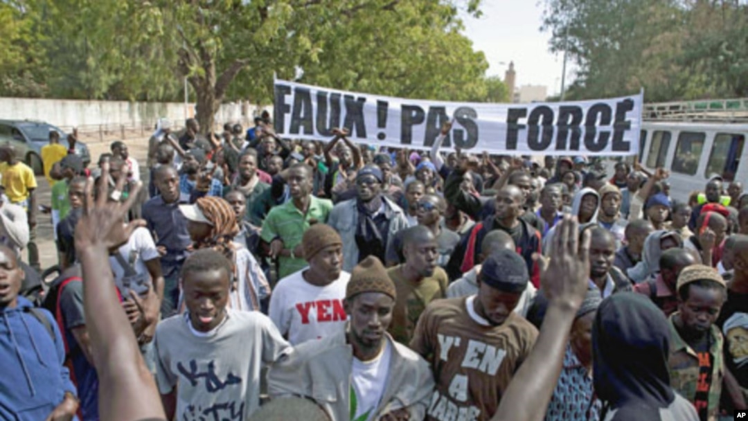 Members of a Senegalese anti-government youth movement Y En A Marre [We're Fed Up] chant slogans during a rally against President Abdoulaye Wade, in the capital Dakar, January 27, 2012.