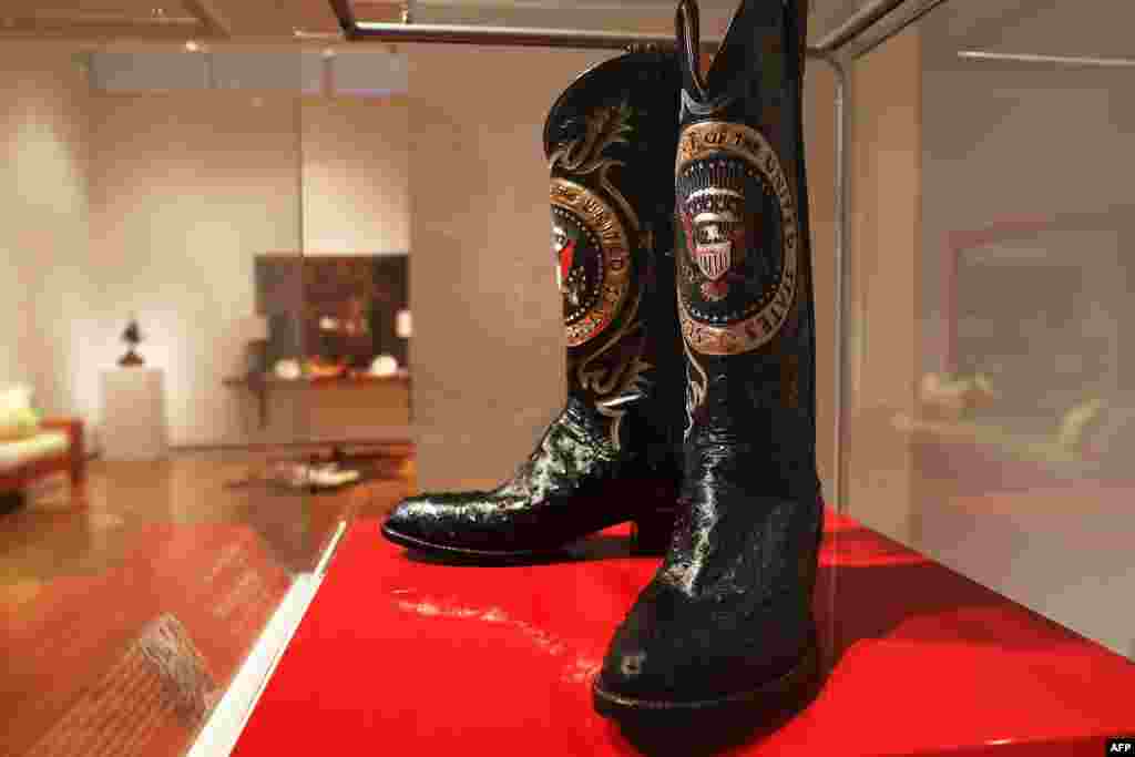 A pair of Ronald Reagan's cowboy boots sit in a case at Christie's where items from the former U.S. president and Nancy Reagan's California home are to be auctioned in New York City. Proceeds from the auction will be donated to the Ronald Reagan Presidential Foundation and Institute.