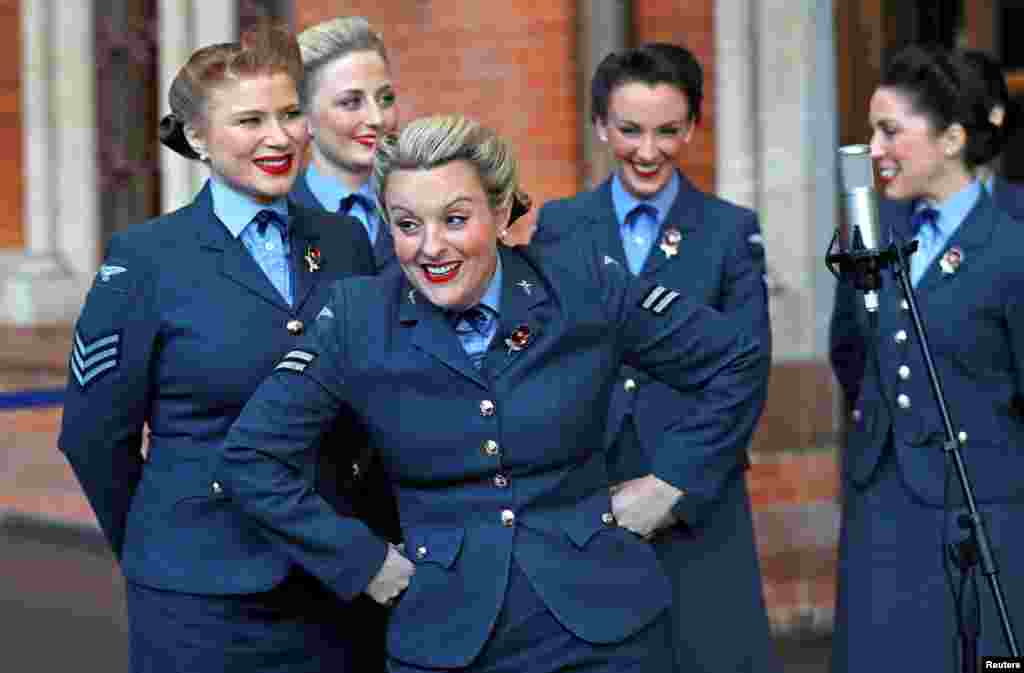 The singing group The D-Day Darlings take part in the unveiling ceremony of a permanent war memorial, created by artist and writer Fabian Peake, at St Pancras International railway station in London.