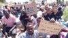 Detainees, now forced to sleep outside their detention center, protested over the weekend, secretly sending pictures to journalists calling for their evacuation to safer countries. Photographed and transmitted to VOA July 7, 2019, in Tripoli, Libya.