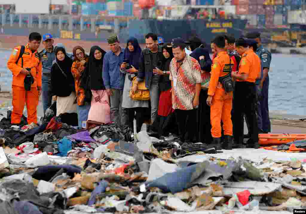 Families of passengers of Lion Air flight JT610 look at the belongings of the passengers at Tanjung Priok port in Jakarta, Indonesia.