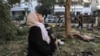 FILE - A woman reacts while holding a pillow as she stands amid debris outside the site of the Ahli Arab Hospital in central Gaza on Oct. 18, 2023, in the aftermath of an overnight strike there.