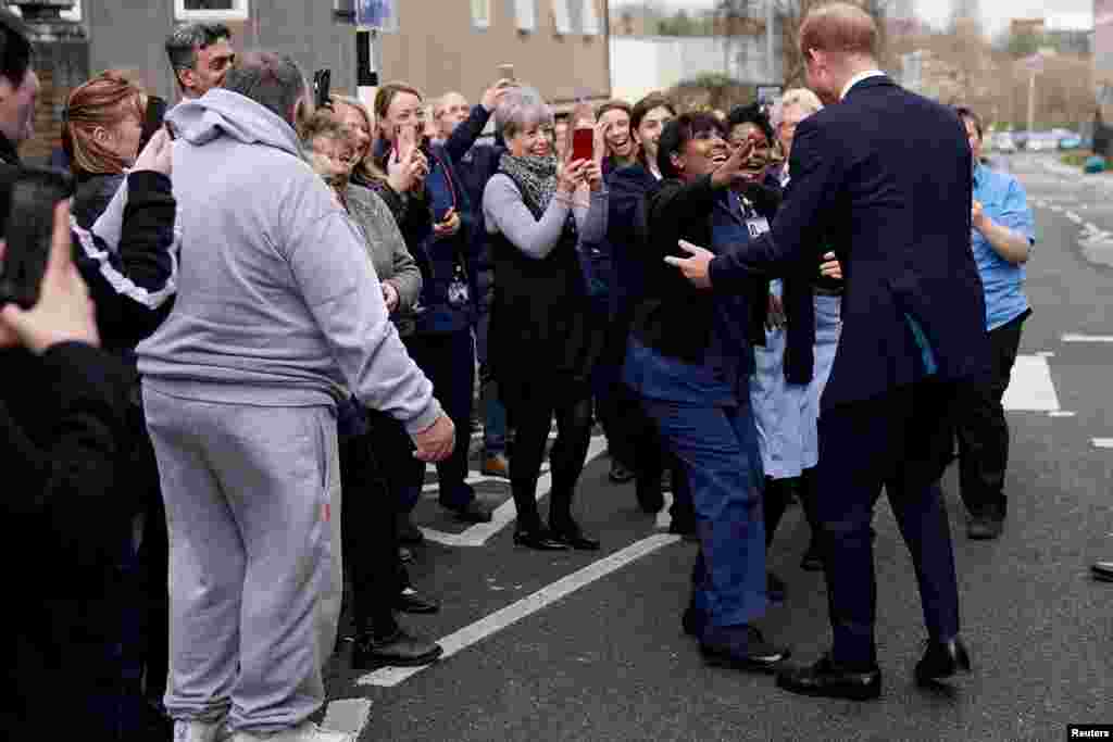 Britain's Prince Harry, Duke of Sussex, is greeted by staff and well-wishers as he leaves The Institute of Translational Medicine at Queen Elizabeth Hospital, in Birmingham.